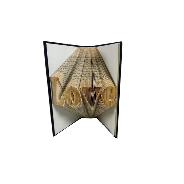 Folded Book Art Love Design Handcrafted Home Decor Romantic Gift of Love. A folded book sculpture spelling 'LOVE' stands open on a textured white surface against a light gray background.