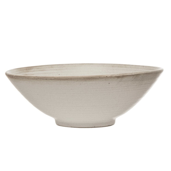 White Stoneware Bowl with Reactive Glaze Rustic Natural Farmhouse Kitchen NEW. A handmade ceramic bowl with a wide, gently sloping rim and a small footed base, shown against a plain white background. The bowl has a textured, speckled finish in a warm off-white or light beige glaze.