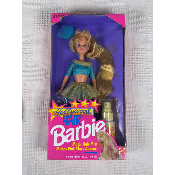 Vintage Barbie Hair doll in its original pink and purple packaging, featuring long blonde hair and a blue top with a green skirt, alongside a bottle of magic hair mist.