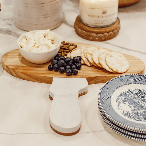 Marble and Wood Mushroom Cutting Board displayed with food