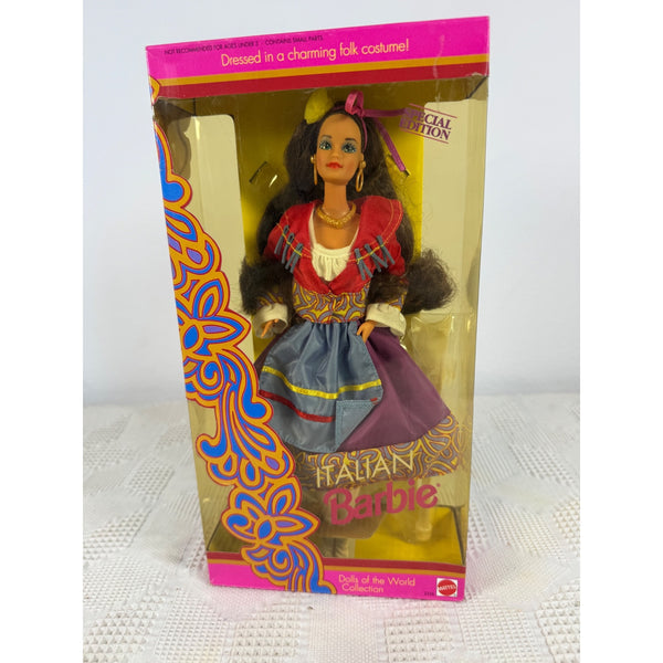 A vintage Italian Barbie doll in its original pink and clear plastic packaging, dressed in a traditional Italian folk costume with a red top, blue skirt, and purple apron. Italian Barbie Dolls Of The World Collection 1992 Special Edition 2256 NIB 