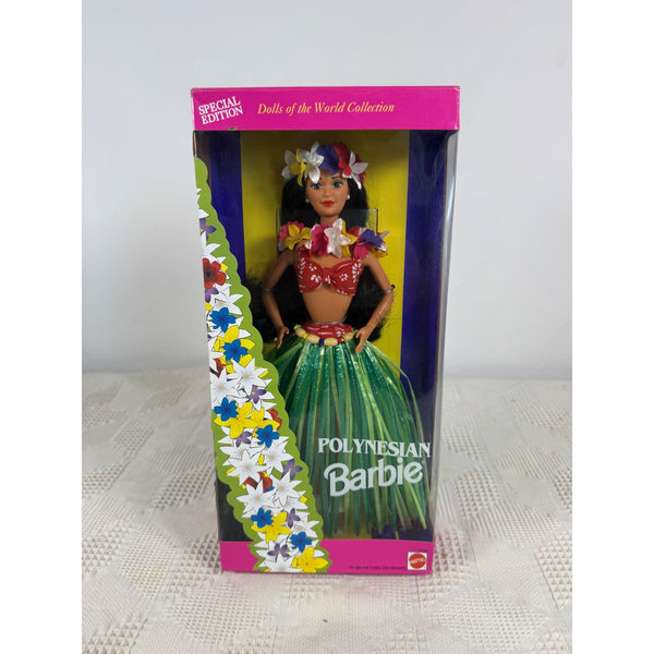 A vintage 'Polynesian Barbie' doll in its original pink and yellow packaging, displayed on a white textured surface against a light gray background. Polynesian Barbie Dolls Of The World Collection 1994 Special Edition 12700 NIB 