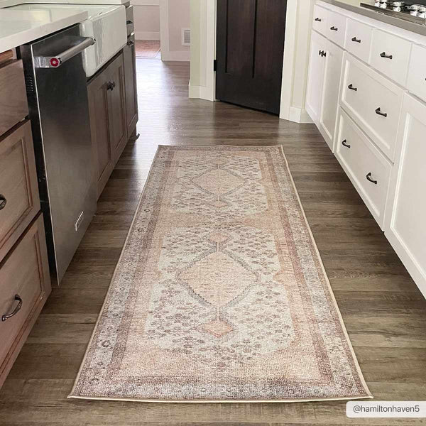 Analu Peach Washable Area Rug in kitchen