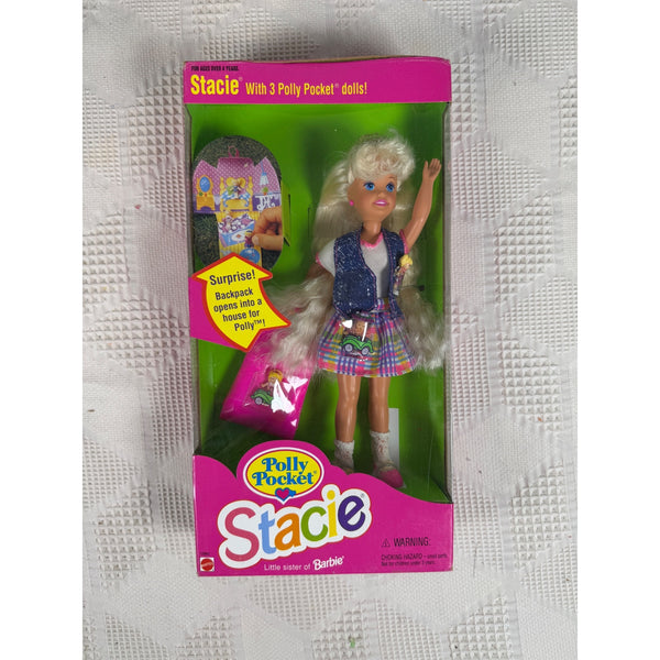 A boxed Barbie doll named Stacie, still in its original retail packaging, placed on a textured white fabric surface. The package shows a blonde doll with a blue patterned top and multicolor skirt, plus a pink backpack accessory pictured on the front. Stacie Doll 3 Mini Polly Pocket Dolls and Backpack 1994 Barbie Sister 12982 NIB
