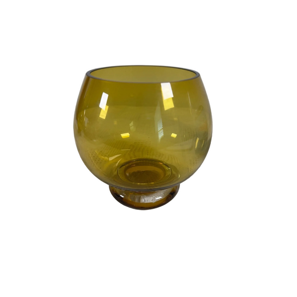 Kresno Amber Glass Bowl From Crate & Barrel Modern Decorative Accent Made Poland (gently used). A translucent amber yellow glass tumbler with a rounded bowl and a short cylindrical base, resting on a textured white surface against a light gray background.