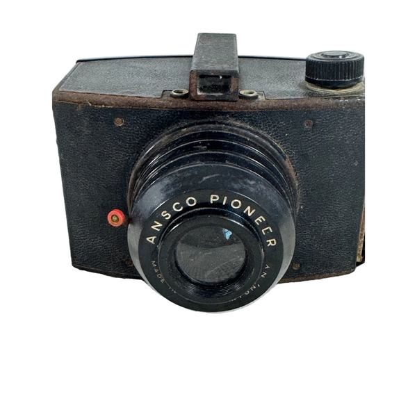 Ansco 616 Pioneer Vintage Box Camera Binghamton NY Photography Collectible. An old black Ansc o Pioneer camera photographed from the front, resting on a textured white fabric surface.