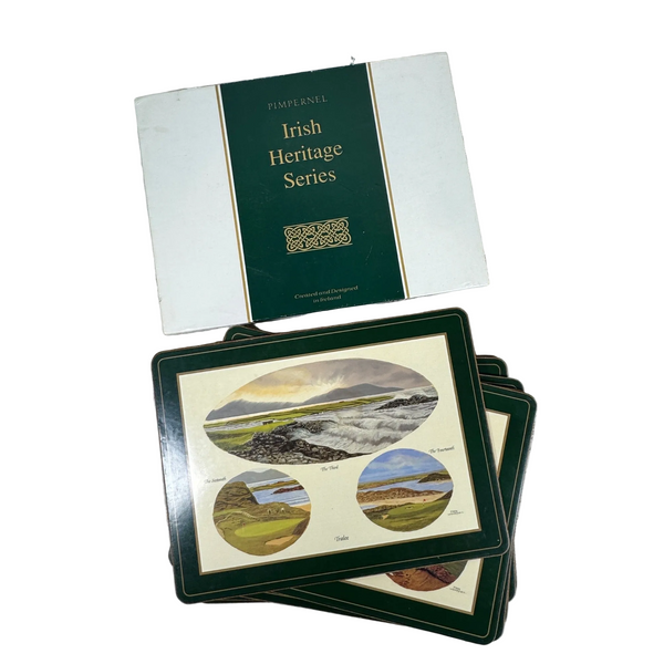 Pimpernel Irish Heritage Series Golf Greats Place Mats Set Of 6 Heat Resistant. A set of 'Finnanel Irish Heritage Series' coasters and matching box, featuring scenic landscape illustrations on a white and dark green background, displayed on a textured white fabric surface.