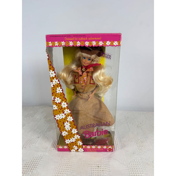 A vintage Australian Barbie doll in its original pink and clear plastic packaging, standing on a white textured surface against a light gray background. Australian Barbie Dolls Of The World Collection 1992 Special Edition 3626 NIB 