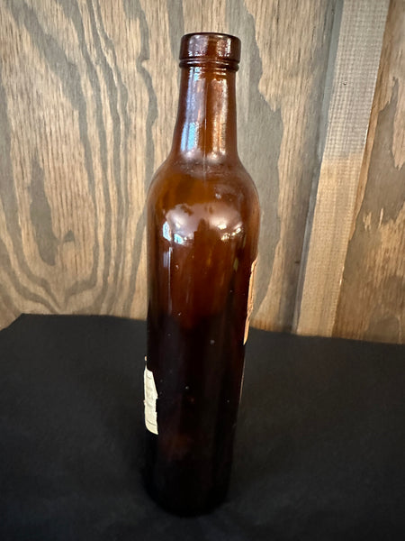Antique Dom Benedictine Amber Bottle side view