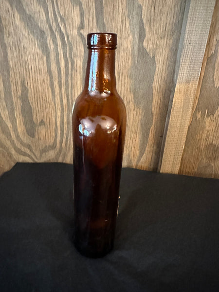 Antique Dom Benedictine Amber Bottle side view