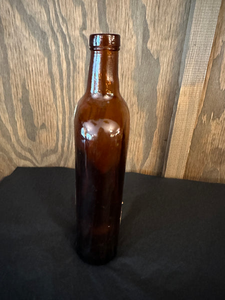 Antique Dom Benedictine Amber Bottle side view