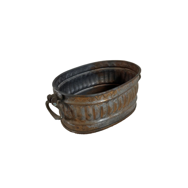 Antique Copper Plated Oval Planter Decorative Brass Handles Patina Finish Egypt. An antique oval metal planter with a decorative embossed pattern and a side handle, resting on a textured white fabric surface against a plain light gray background.