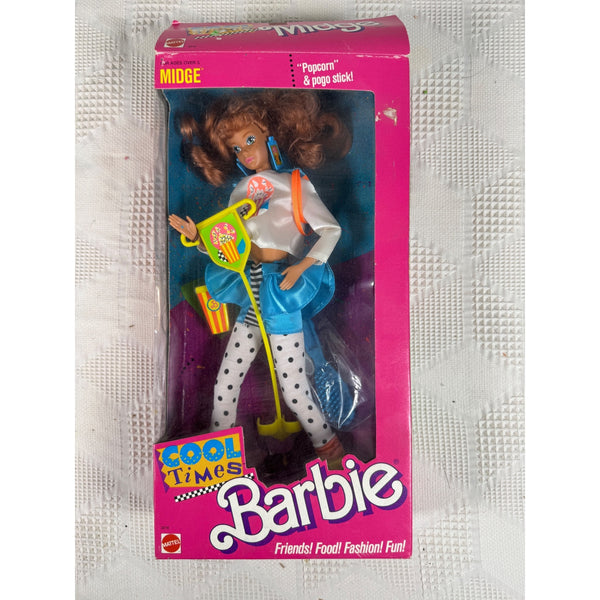 Vintage 1990s Barbie doll in its original pink packaging, featuring a doll with brown hair wearing a white top, blue skirt, and white polka-dot pants, holding a yellow scooter accessory. Cool Times Barbie Doll Midge 1990s Mattel Friends Food Fashion Fun 3216 NIB