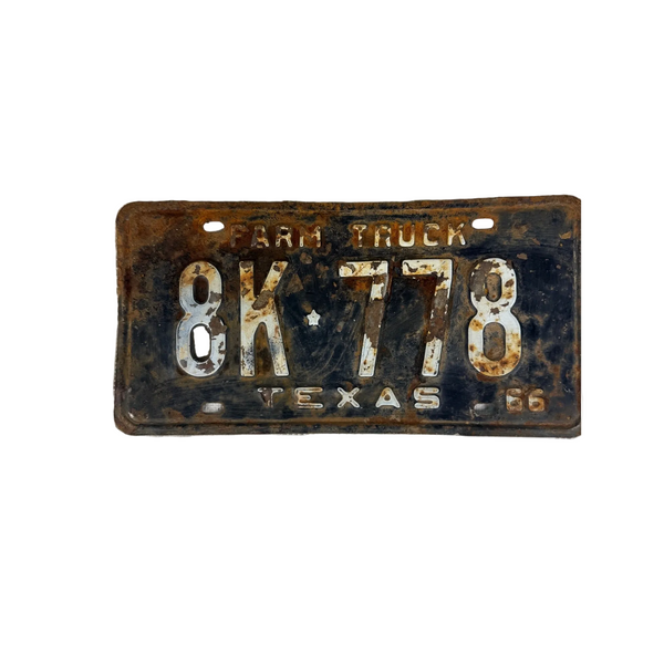 Vintage 1966 Texas Farm Truck License Plate 8K 778 Black w White Embossed Text. A vintage 1966 Texas farm truck license plate with the number 8K778, showing significant rust and wear, placed on a textured white fabric background.