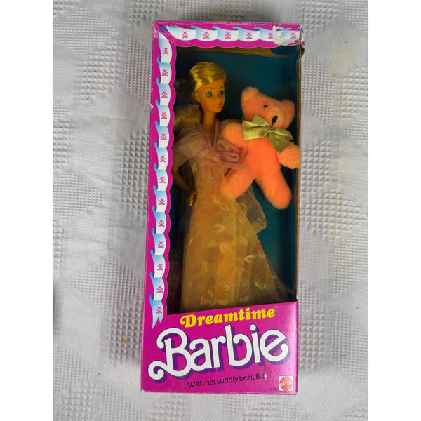 Vintage Dreamtime Barbie doll in its original pink window box packaging, holding a plush pink teddy bear with a green bow. The box features the 'Dreamtime Barbie' logo.