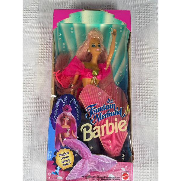 Fountain Mermaid Barbie Doll 1993 Mattel Pink Hair Fountain Crown 10393 NIB. Barbie Fountain Mermaid doll in its original retail packaging, featuring a pink mermaid-themed box with a doll that has pink hair and a pink shell-like tail, photographed against a textured white background.