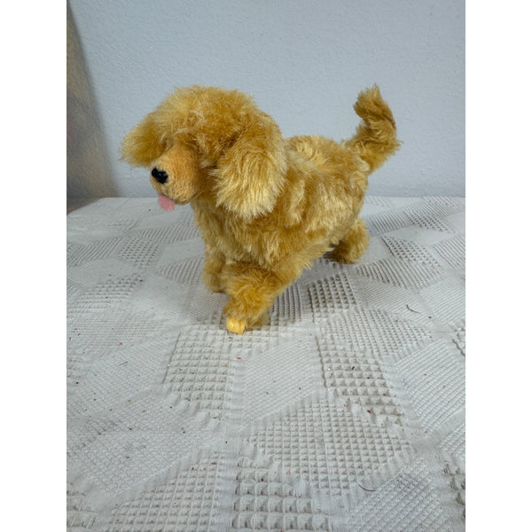 Vintage 1997 Barbie Ginger Walking Toy Dog Battery Operated Plush Collectible. A golden-brown plush dog toy standing on a textured white blanket against a plain light gray wall.
