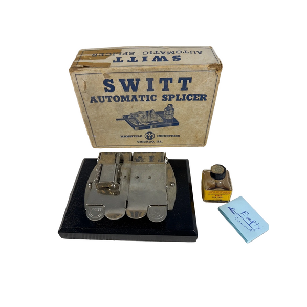 Switt Automatic Splicer by Mansfield Industries w Box Vintage Film Editing Tool. Vintage Switt Automatic Splicer shown with its original cardboard box, a small bottle of lubricant, and a blue Switt card on a white textured blanket background.