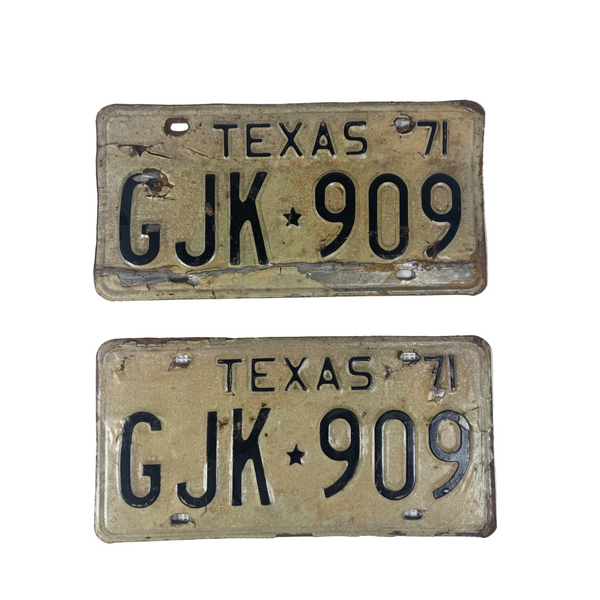 Vintage 1971 Texas License Plates Pair GJK 909 Black Embossed Text on White . Two vintage 1971 Texas license plates with the registration GJK 909, displayed on a textured white fabric background.