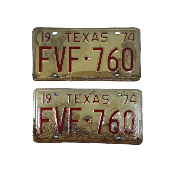 Vintage 1974 Texas License Plates FVF 760 Pair White and Red Embossed Lettering. Two vintage 1974 Texas license plates with the plate number FVF 760, featuring a distressed gold/brass background and red lettering, displayed on a white textured fabric background.