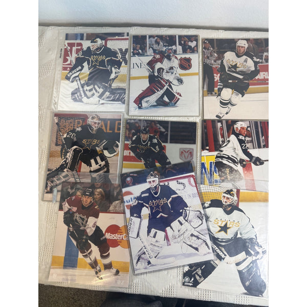 Rare Manny Fernandez Autographed Dallas Stars Photo and Hockey Photo Collection . A collection of hockey trading cards displayed in a clear plastic binder sleeve, featuring players from the Nashville Predators and other teams on a white background.