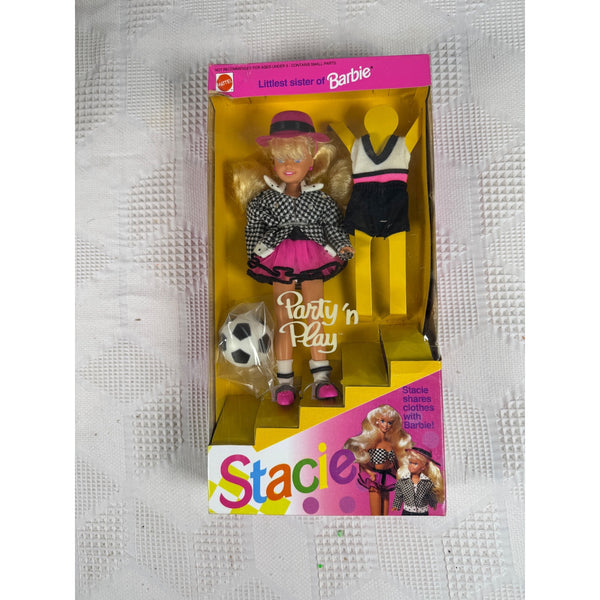 Vintage Stacie Barbie doll in its original packaging, featuring a blonde doll dressed in a black-and-white checkered top and pink skirt, with a soccer ball accessory and a second outfit displayed inside the box. Stacie Little Sister of Barbie Party N Play Doll 1992 Mattel Outfit 5411 NIB