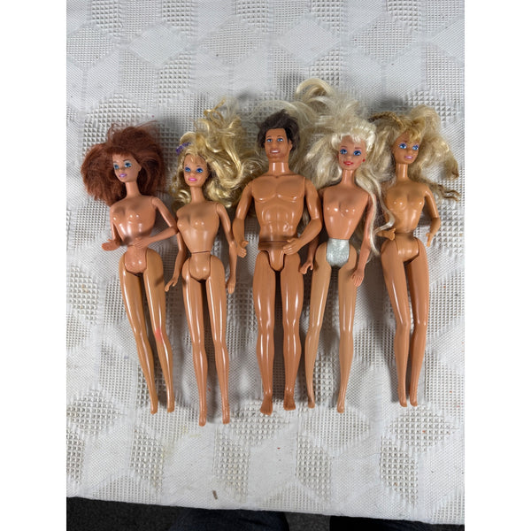 Vintage Barbie and Ken Dolls 1980s to 1990s Lot Of 5 Mixed Styles and Hair . Five vintage plastic dolls with various hair colors and skin tones, arranged side-by-side on a textured white fabric background.