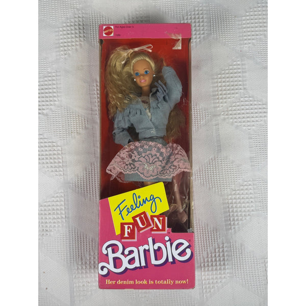 Vintage 1985 Feeling Fun Barbie doll in its original pink window packaging, featuring a blonde doll in a denim shirt and patterned skirt, set against a textured white background.