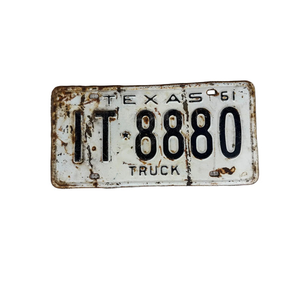 Vintage 1961 Texas Truck License Plate IT 8880 White w Embossed Black Lettering . A vintage 1961 Texas license plate reading 'IT 8880 TRUCK' with rust and wear, placed on a textured white surface.