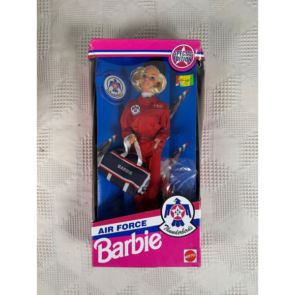 Vintage Barbie Air Force Thunderbird doll in its original window box packaging, featuring a blonde doll in a red flight suit holding a matching bag, set against a blue and pink background. Barbie Air Force Thunderbirds Special Edition Doll 1993 Mattel 11552 NIB