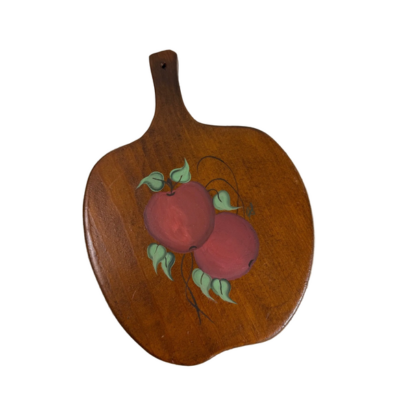 Vintage Hand Painted Wooden Cutting Board w Red Apple Design Rustic Kitchenware . A vintage wooden serving board or paddle with a painted design of two red apples and green leaves, resting on a white textured fabric background.