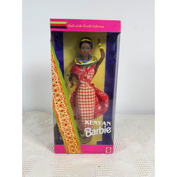 Kenyan Barbie doll in its original packaging, featuring a traditional red and white gingham dress and colorful accessories, set against a plain light background. Kenyan Barbie Dolls Of The World Collection Special Edition 1993 11181 NIB