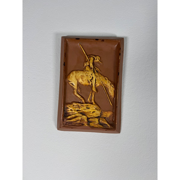 Vintage Plaster Relief Wall Art Native American On Horse End Of The Trail Style . A rectangular brown ceramic wall plaque featuring a raised relief sculpture of a warrior on horseback holding a spear, mounted on a light gray wall.