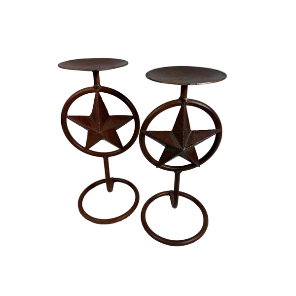 Rustic Metal Texas Star Design Pillar Candle Holders Set Of 2 Western Style . A pair of rustic metal candle holders with a circular star design and round tops, shown on a textured white surface against a light gray background.