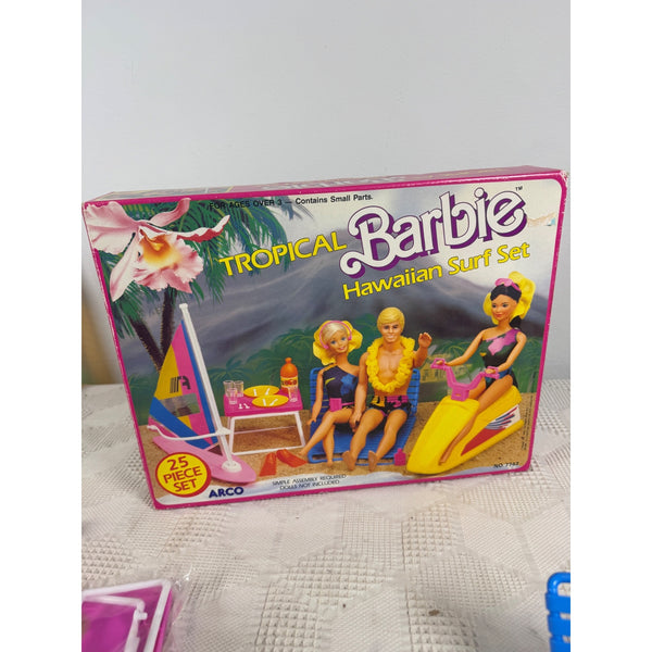 Tropical Barbie Hawaiian Surf Set Playset Vintage 1986 Mattel Arco Accessories. Tropical Barbie Hawaiian Surf Set toy box by ARCO, featuring illustrated Barbie dolls with surfboard, surfboard set, and yellow jet ski on the front packaging.