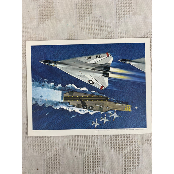 United States Navy F111B Fighter Jet Art Print Aircraft Carrier Vintage Military. A vintage-style military art print depicting fighter jets and an aircraft carrier on the blue ocean, placed on a textured white surface.