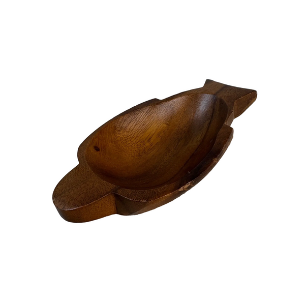 Hand Carved Monkey Pod Wood Sea Turtle Shaped Trinket Bowl Made In Philippines . A carved wooden bowl with a fish-like silhouette, resting on a textured white quilted blanket against a white wall.