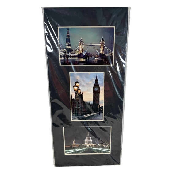 London Photo Collage 3 Matted Images Tower Bridge Big Ben St Pauls Cathedral NEW. A vertical black photo collage print featuring three London landmarks—Tower Bridge, Big Ben, and the Westminster Bridge—encased in a clear plastic sleeve and standing against a light gray wall.