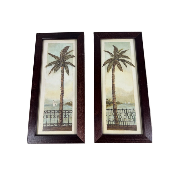 Set Of 2 Tropical Palm Tree Framed Art Prints Wooden Frames Beach Coastal Decor Gently Used. A pair of framed vertical art prints featuring palm trees by the sea, displayed side-by-side on a textured white fabric background.
