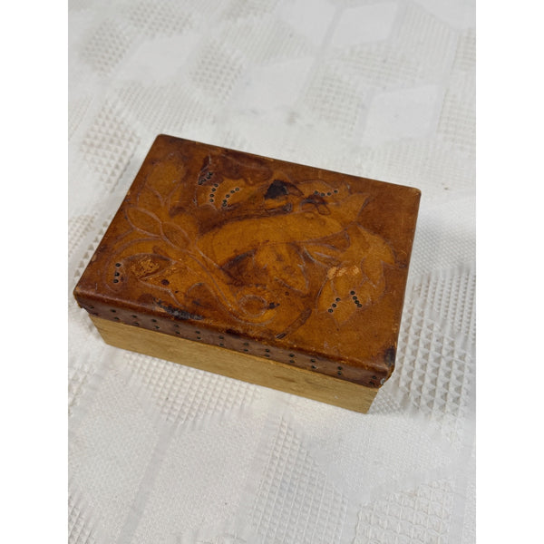 Hand Carved Vintage Wooden Trinket Box w Embossed Leather Floral Design c1950s. A small rectangular wooden box with a hinged lid, featuring hand-painted brown fox illustrations on the lid and a light natural wood base, resting on a white textured fabric surface.