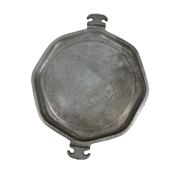 Guardian Service Octagonal Aluminum Griddle Plate w Handles Vintage Cookware. An antique octagonal metal tray or lid with two small loop handles, shown on a textured off-white surface.