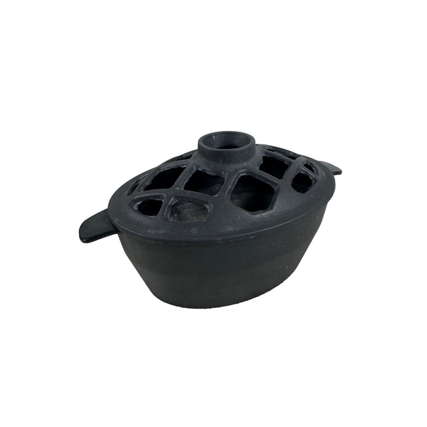 John Wright Cast Iron Stovetop Humidifier Potpourri Steamer Lattice Style Lid. A black cast iron pot lid with a lattice-style ventilation hole design and side handles, resting on a textured white tablecloth.