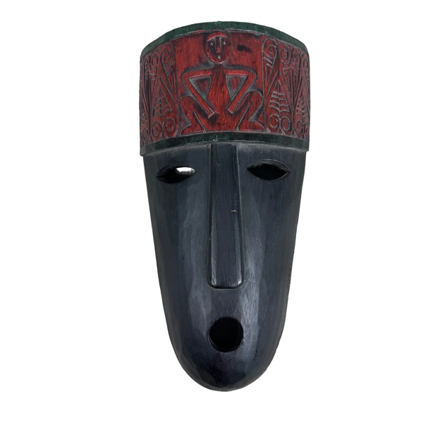 Hand Carved Wooden Tribal Mask Red & Black Finish Wall Hanging Temor Indonesia. A carved wooden mask with a dark black body and a red patterned upper section, photographed against a textured off-white fabric background.