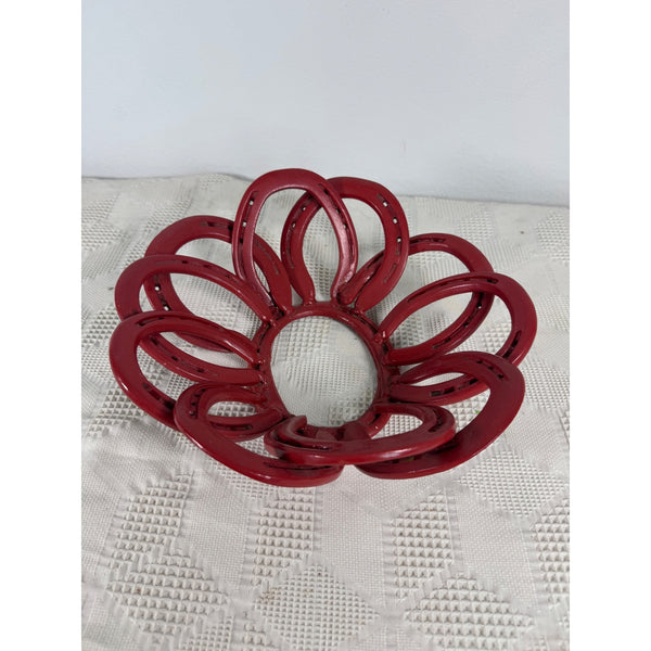 Red Handmade Horseshoe Bowl 12 Inch Rustic Metal Decor Rustic Farmhouse Western. A decorative red metal bowl with a petal-like layered design, resting on a textured white surface against a plain light background. 