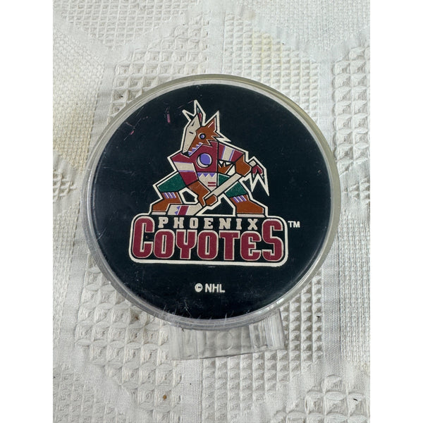 Phoenix Coyotes NHL Official Licensed Hockey Puck Ravens Athletic by Vegum. A round Phoenix Coyotes NHL puck on a textured white paper towel background.