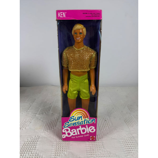 Ken Sun Sensation Barbie doll in its original packaging, featuring a blonde doll wearing a gold mesh crop top and lime green shorts, with pink packaging. Ken Sun Sensation Barbie Doll Vintage 1991 Mattel Hot Summer Look 1392 NIB