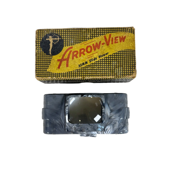 Arrow-View 35MM Slide Viewer w Original Box Vintage by Arrow Metal Products. A vintage Arrow-View 35mm slide viewer shown with its original box. The slide viewer is a dark gray plastic device with a clear viewing window, wrapped in protective plastic.