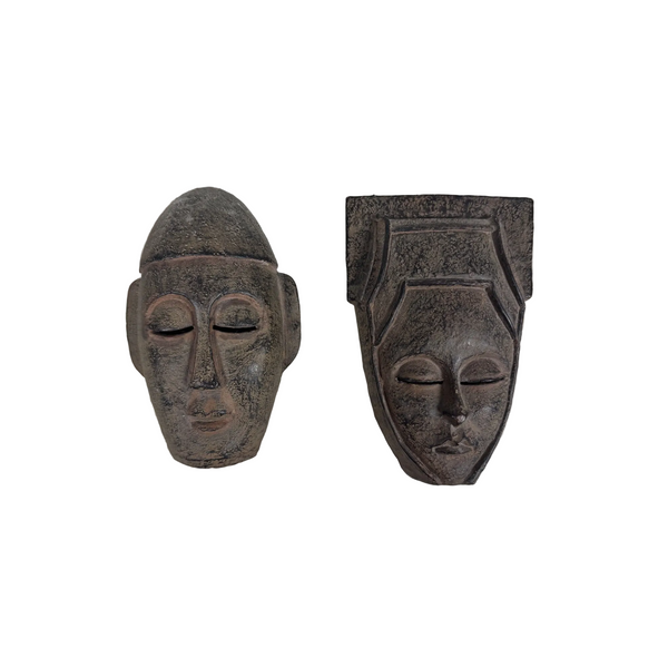 African Inspired Small Wall Hanging Mask Duo Rustic Finish Tribal Art Decor. Two dark carved decorative masks or face sculptures displayed side by side on a textured white fabric background.