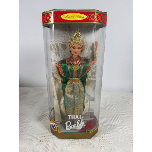 A vintage Thai Barbie doll in its original collector's packaging, featuring a doll dressed in a traditional green and gold Thai outfit with a gold crown, inside a clear hexagonal display box. Thai Barbie Doll Collector Edition 1997 Dolls Of The World Mattel 18561 NIB