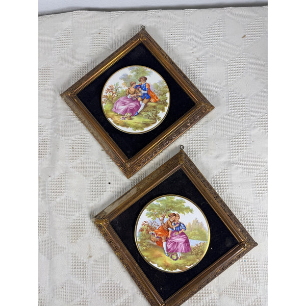 Pair Of Framed Limoges Porcelain Plaques By Fragonard Depicting Romantic Scenes. Two small framed vintage paintings featuring painted couples in outdoor scenes, mounted on a textured white fabric background.